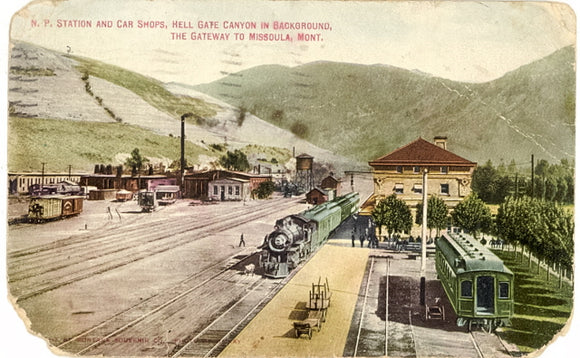 N. P. Station and Car Shops, Hell Gate Canyon in Background, The Gateway to Missoula, MT - Carey's Emporium