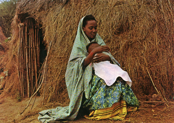 A Muhuma Mother With a Baby Outside Their House - Carey's Emporium