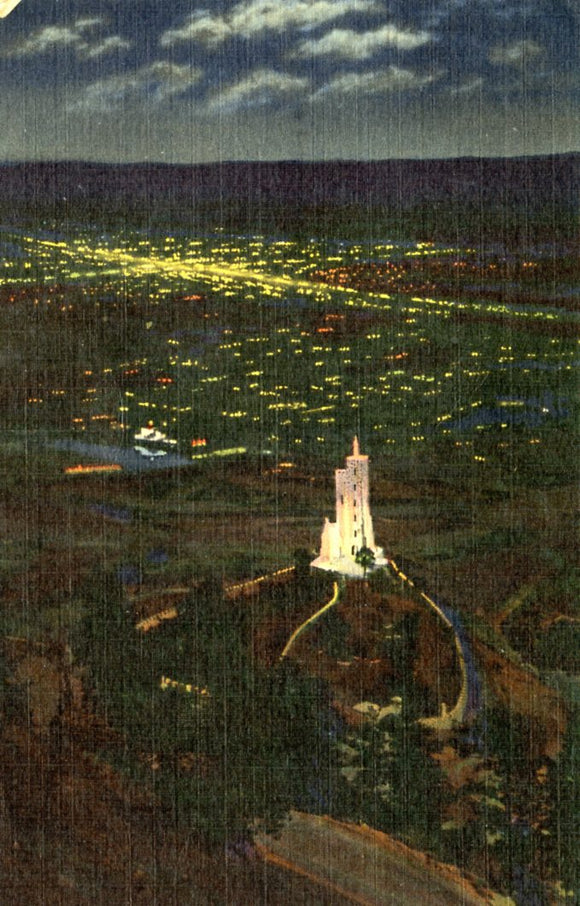 Will Rogers Shrine of the Sun, at Night, with the Lights of Colorado Springs in Background - Carey's Emporium